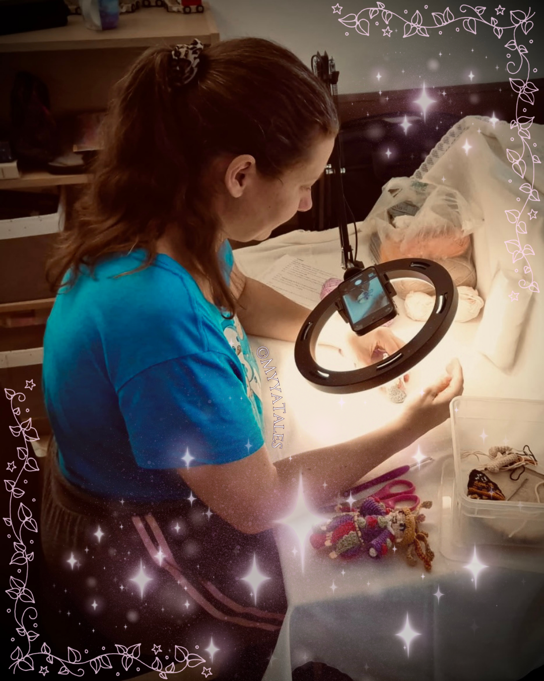 Crochet designer Myya meticulously crafting a fantasy amigurumi doll at her desk under a ring light, showcasing 20 years of textile art experience.