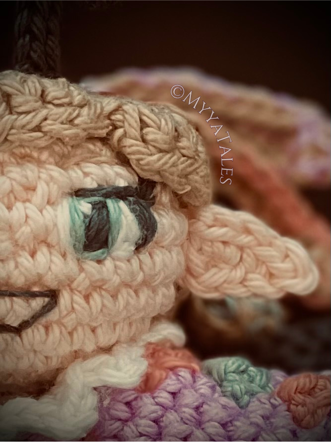 Close-up of a mystical crochet fairy with expressive eyes, Amigurumi fairy pattern, artistic crochet doll detail.